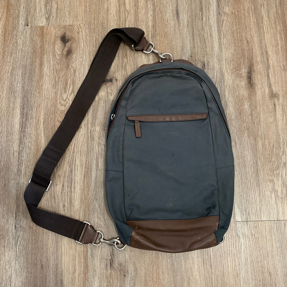 Coach 2013 canvas sling backpack in navy blue w/ brown leather panels - 13x18in